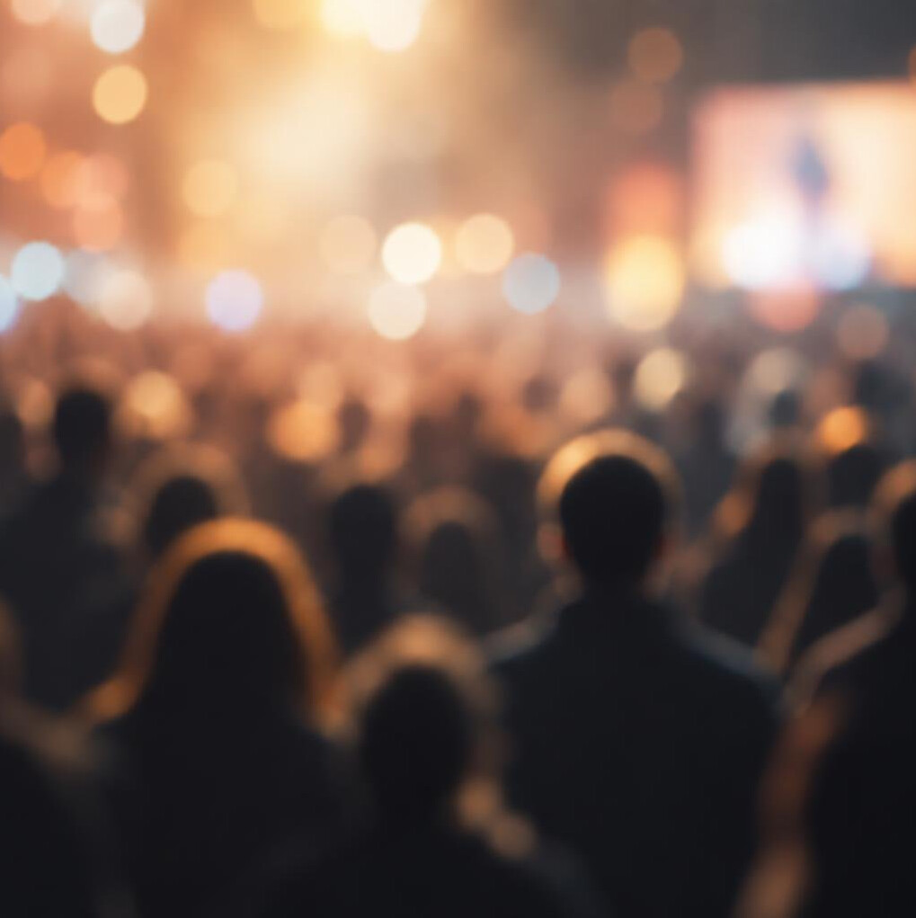 Blurred silhouettes of a crowd of people at a distance