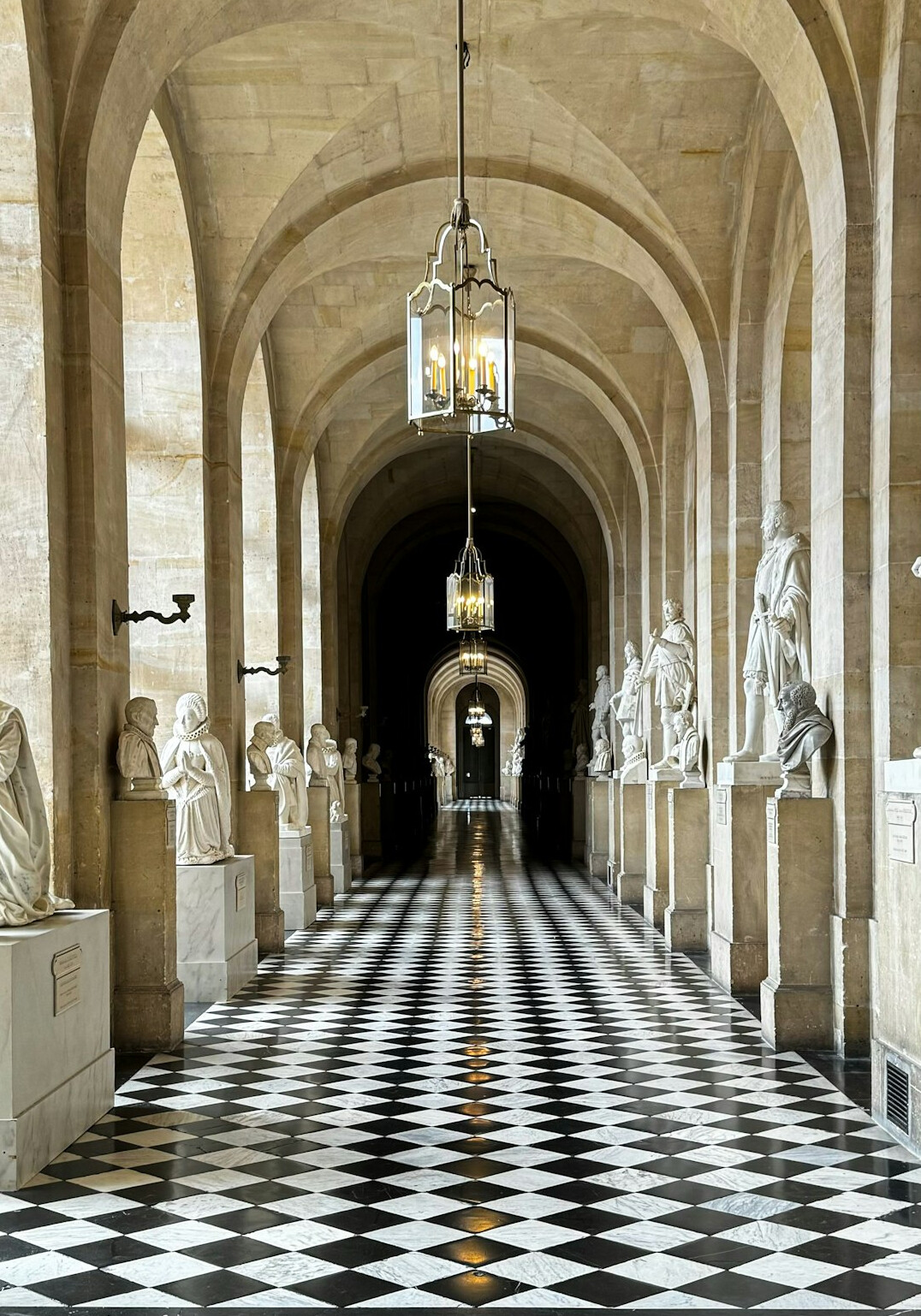 Long museum corridor with marble floor and soft lighting
